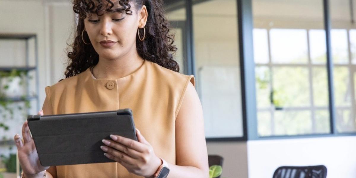 1.	Woman wearing earrings while holding a tablet in a modern office