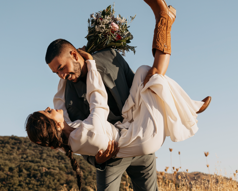 Man holding woman in arms