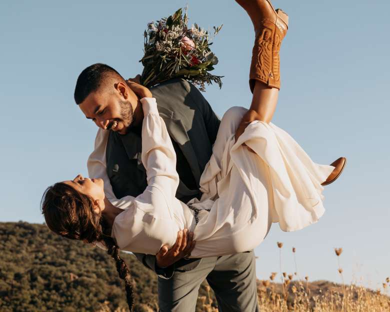 Man holding woman in arms 