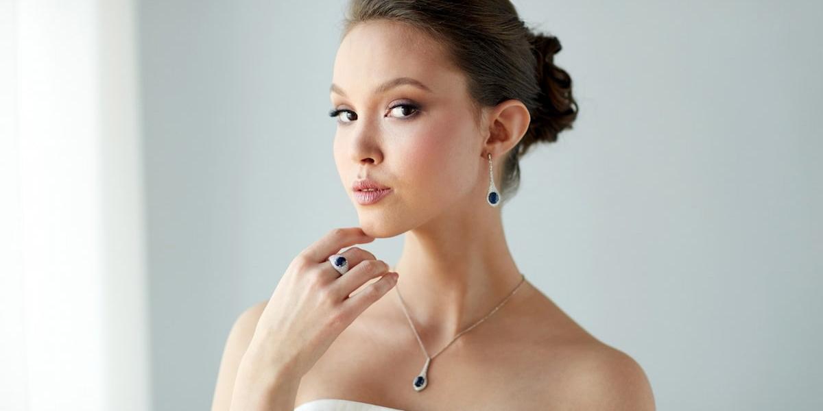An elegant woman wearing a topaz and diamond jewellery set