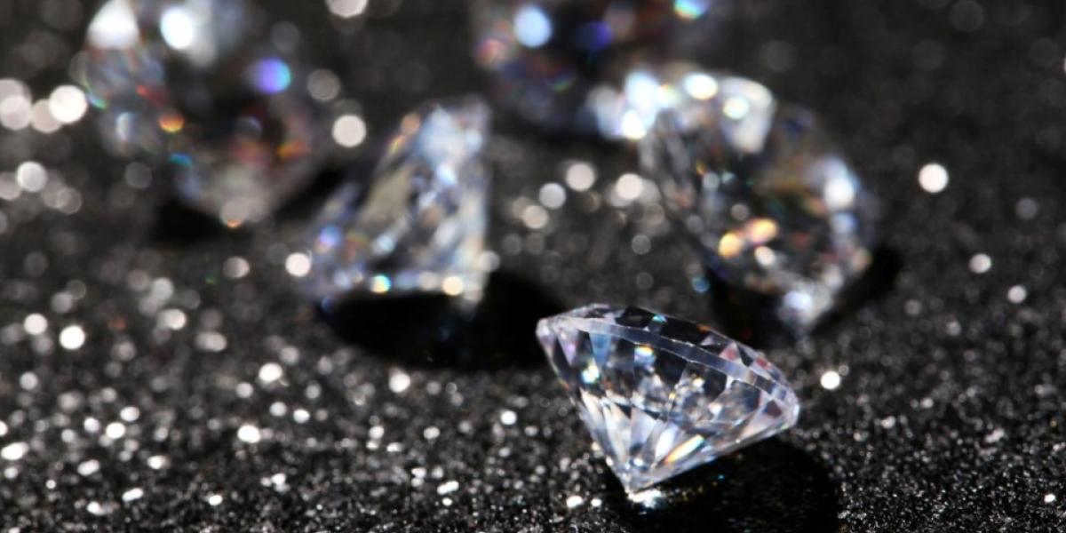 1.	Close-up of many diamond stones on a dark, shiny background