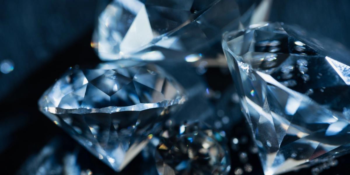 Close up of pure transparent diamonds on black background.