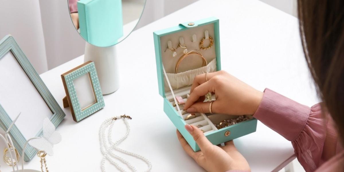 woman selecting jewellery from jewellery box